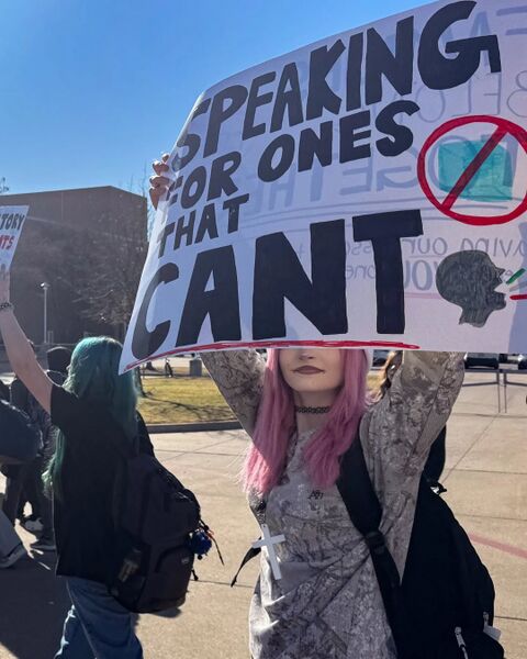 File:Student Holds A Protest Sign.jpg